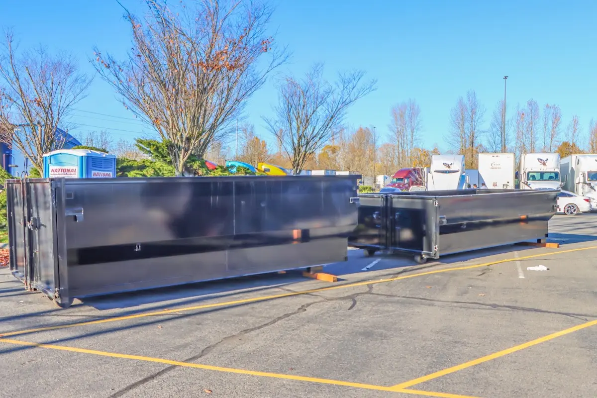 Professional dumpster rental service with roll-off container on residential driveway in Clemmons